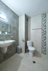 a bathroom with a toilet and a sink at Peneka Hotel in Pomorie