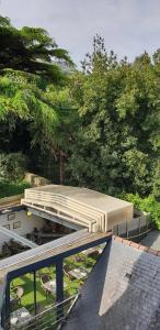 a canopy on top of a building with trees at Hôtel Restaurant Corto Maltese in Le Palais