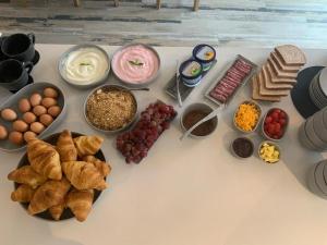 a bunch of different types of food on a table at SALT Boutique Guesthouse by CURIOCITY in Bloubergstrand