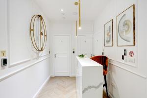a white bathroom with a sink and a mirror at Club boutique rooms in Split +28 photos