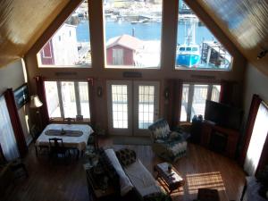 a living room with a view of a boat in the water at Sal's Bed and Breakfast by the Sea in Herring Cove