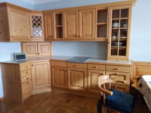 a kitchen with wooden cabinets and a table at Apartment (3 Gerste) in Hargelsberg