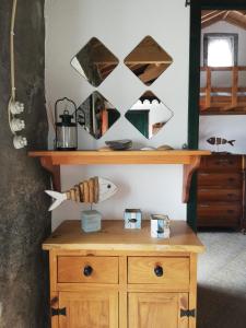 a room with a wooden cabinet and a mirror at Fisherman's House Azores in Angra do Heroísmo