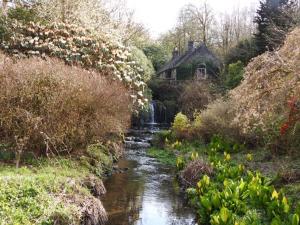 a stream in front of a house next to a river at Finlaystone Barns in Port Glasgow