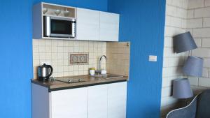 a kitchen with a sink and a microwave at Villa Edelweiss in Sveti Stefan