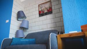 a living room with two blue chairs and two lamps at Villa Edelweiss in Sveti Stefan