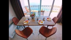 a table with plates of food on a balcony at Villa Edelweiss in Sveti Stefan