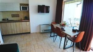 a kitchen and dining room with a table and chairs at Villa Edelweiss in Sveti Stefan