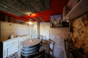 a room with a table and a counter with a barrel at Country House Olive Garden in Gorica