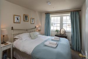 a bedroom with a bed with towels on it at Lady Margaret's in Bath +28 photos