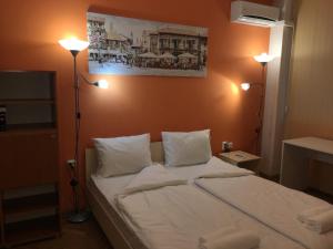 a bedroom with a bed with two lights on it at Apartment Dima in Varna City