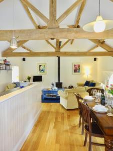a living room with a table and a couch at Glanhenwye Courtyard Cottages in Glasbury