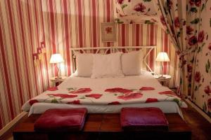 a bedroom with a bed with two pillows on it at Hôtel Kastell Dinec'h in Minihy-Tréguier