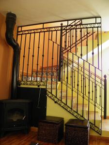 a spiral staircase in a room with a fireplace at Casa Rural del Aire Torrellas TarazonaMoncayo in Torrelles