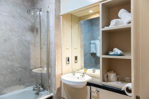 a bathroom with a sink and a shower and a toilet at The Parsonage Hotel & Spa in Escrick