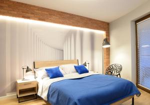 A bed or beds in a room at Apartamenty Gaja