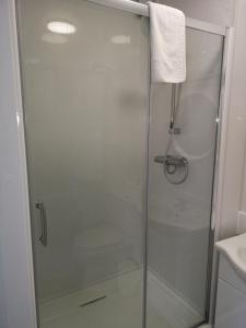 een douche met een glazen deur in de badkamer bij The Lawton in Blackpool