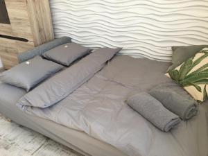 a bed with pillows on top of it at Apartament Armia in Gdynia