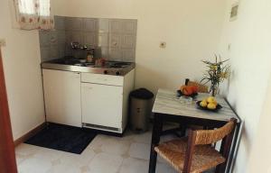a small kitchen with a table and a sink at Studio Savvas in Melíkia