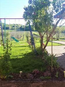 a park with an empty playground with a swing at Gite "Au cerf" in Nothalten