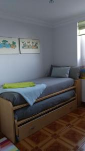 a bedroom with a bed with blue sheets at Lekeitio Paraiso in Lekeitio