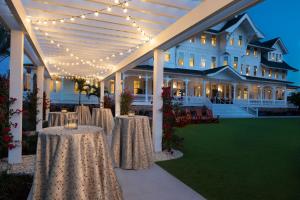 a marquee with tables and lights in front of a building at Belleview Inn in Belleair