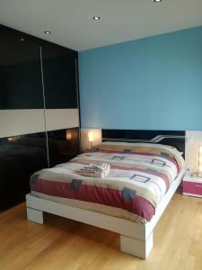 a bedroom with a bed with a blue light on it at Villa Dalia in Suances