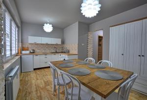 a kitchen with a large wooden table and chairs at Apartament Dworcowa 4 in Ustrzyki Dolne