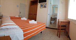 Posteľ alebo postele v izbe v ubytovaní Hotel Amalfi