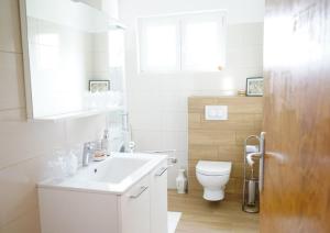 a white bathroom with a sink and a toilet at Apartman Suzy in Pula +32 photos