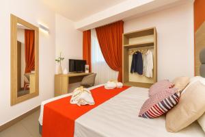 Posteľ alebo postele v izbe v ubytovaní Travini Hotel Residence