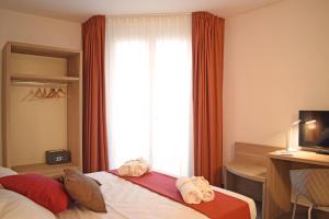 Posteľ alebo postele v izbe v ubytovaní Travini Hotel Residence