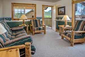 a living room with couches and chairs and a porch at Stanley High Country Inn in Stanley