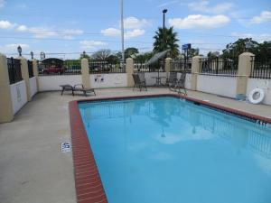 a swimming pool at a hotel with blue water at Executive Inn & Suites West Columbia in West Columbia