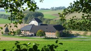 a large house in the middle of a green field at Apartment (4 Dinkel) in Hargelsberg