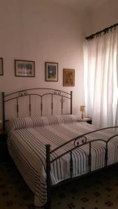 a bedroom with a bed and a window at Via Scappini in Rio Marina