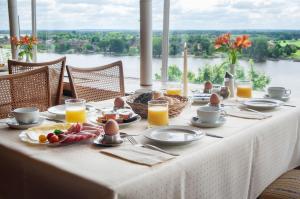 a table with eggs and food on it with a view at Hotel Bellevue in Lauenburg