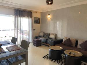 a living room with a couch and a table at Asilah Marina Golf A3 in Asilah