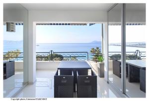 a view of the ocean from the balcony of a house at Beautiful modern apartment in La Croisette with sea view in Cannes