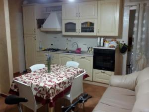 a kitchen with a table with a red and white table cloth at Lattanzio's Residence in Margherita di Savoia