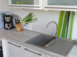 a kitchen counter with a stainless steel sink at York Cottage Heaven in Traben-Trarbach