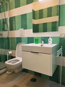 a bathroom with a toilet and a sink at Caponapoli 8 in Naples