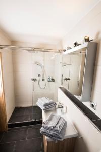 a bathroom with a shower and a sink and a mirror at Ferienwohnung Rosenhof in Berchtesgaden