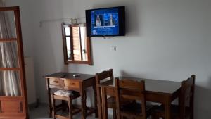 a dining room with a table and a tv on the wall at Hotel Apollonio in Nikópolis