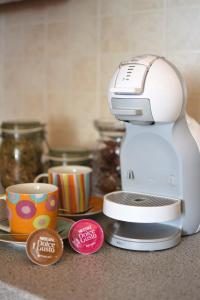 a mixer sitting on a counter next to cups at Apartment Bc in Bovec +6 photos