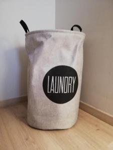 a gray laundry bag sitting on a wooden floor at appartement oostende vlak bij zee in Ostend