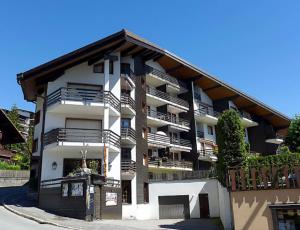 a large building with balconies on the side of it at Villars soleil in Villars-sur-Ollon