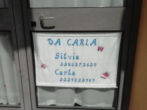 a sign on a glass door with butterflies on it at Affittacamere Da Carla in Bonassola