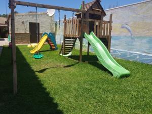 a playground with a slide and a play house at Residencial La Teja in Zahora