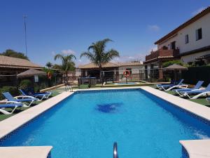 a swimming pool with lounge chairs and a swimming pool at Residencial La Teja in Zahora